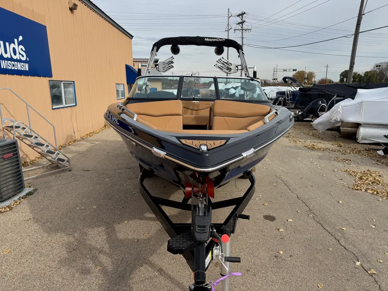 Slide: The Image of 2021 MasterCraft XT23 boat parked on a trailer. - 24