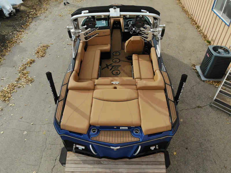 Slide: The Image of Aerial view of 2021 MasterCraft XT23 boat with brown seating. - 29