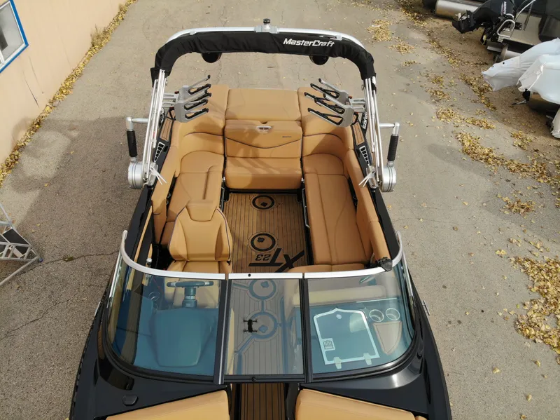 Slide: The Image of Aerial view of 2021 MasterCraft XT23 boat with brown seating. - 30