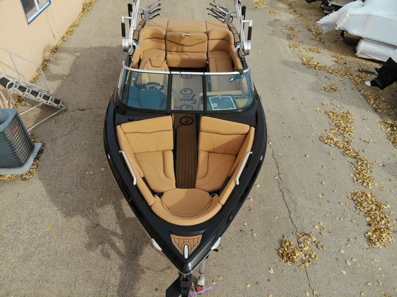 Slide: The Image of Aerial view of a 2021 MasterCraft XT23 boat with brown seating. - 31