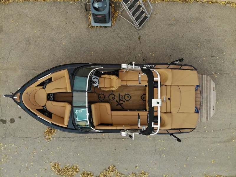 Slide: The Image of Aerial view of 2021 MasterCraft XT23 boat with brown seating. - 34