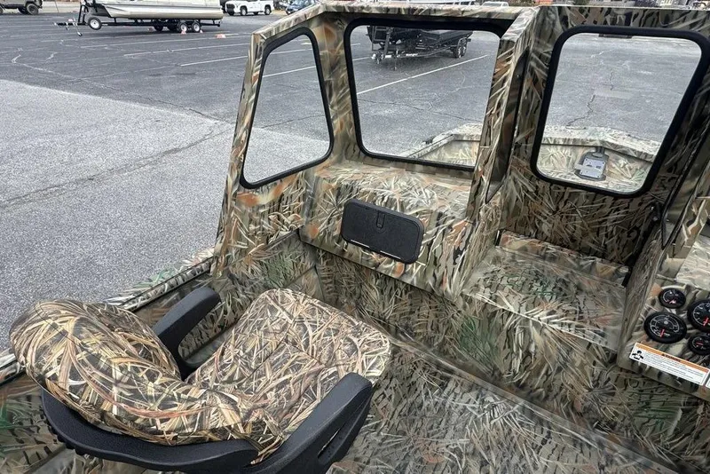 Slide: The Image of 2026 SeaArk 1872 MVJT boat interior with camouflage design and seating. - 13