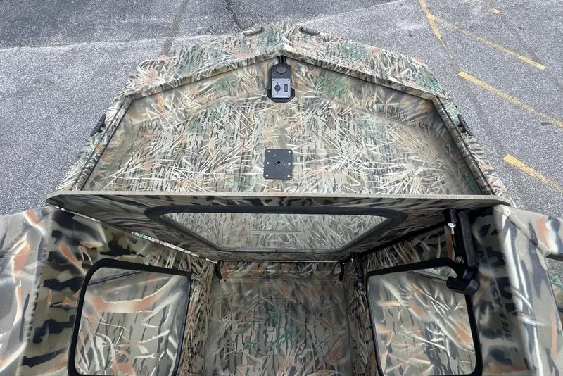 Slide: The Image of 2026 SeaArk 1872 MVJT boat interior with camouflage design, featuring storage compartments. - 14