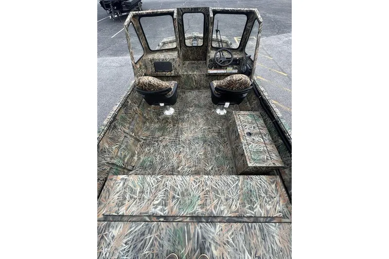 Slide: The Image of 2026 SeaArk 1872 MVJT boat interior with camouflage design and dual seating. - 2