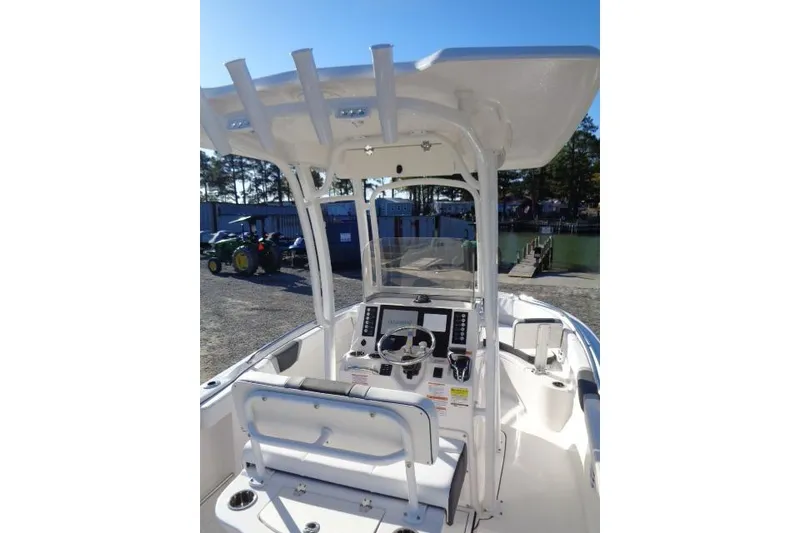 Slide: The Image of 2026 Robalo R222 Center Console boat with modern helm and seating, dockside view. - 12
