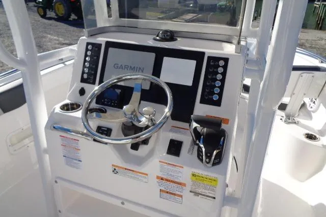 Slide: The Image of 2026 Robalo R222 Center Console boat dashboard with Garmin navigation system. - 13
