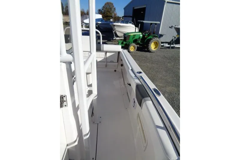 Slide: The Image of 2026 Robalo R222 Center Console boat interior with white seating and railings. - 16