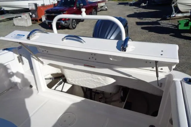 Slide: The Image of 2026 Robalo R222 Center Console boat with open storage compartment in a sunny outdoor setting. - 19