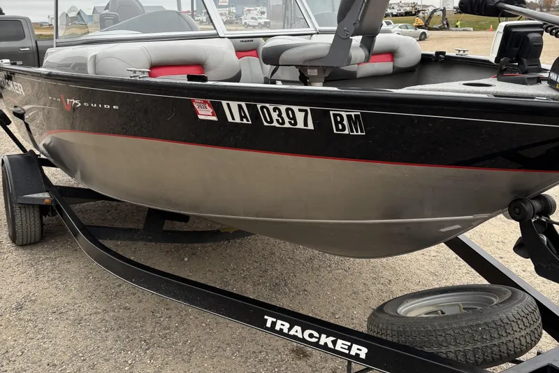 Slide: The Image of 2013 Tracker Pro Guide V-175 Combo boat on trailer, parked on gravel. - 11