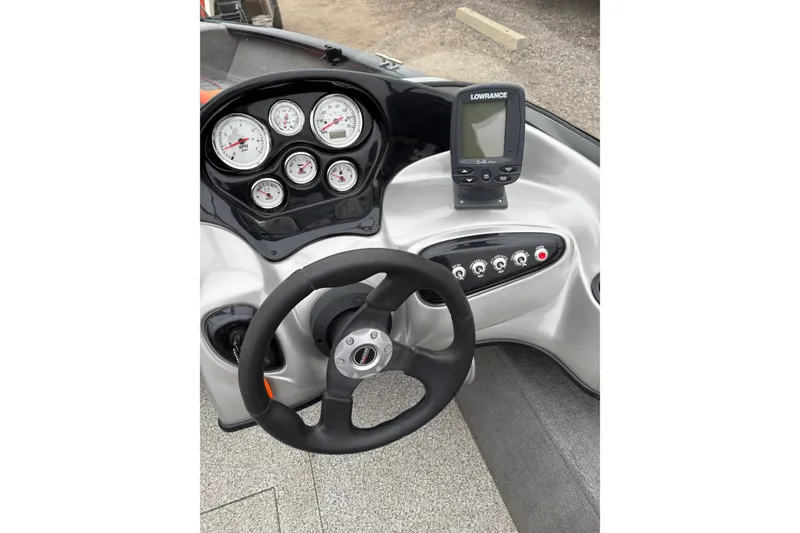 Slide: The Image of 2013 Tracker Pro Guide V-175 Combo boat dashboard with steering wheel and gauges. - 14