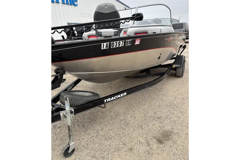 Slide: The Image of 2013 Tracker Pro Guide V-175 Combo boat on trailer, parked outdoors. - 3