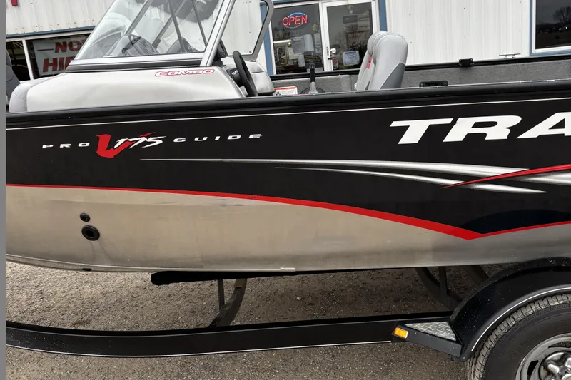 Slide: The Image of 2013 Tracker Pro Guide V-175 Combo boat, black and silver exterior, parked on trailer. - 5