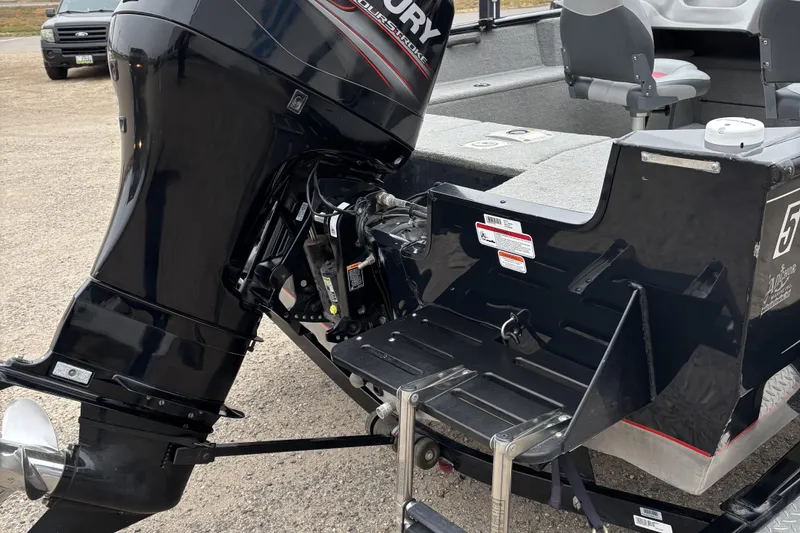 Slide: The Image of 2013 Tracker Pro Guide V-175 Combo boat with Mercury outboard motor, rear view. - 8