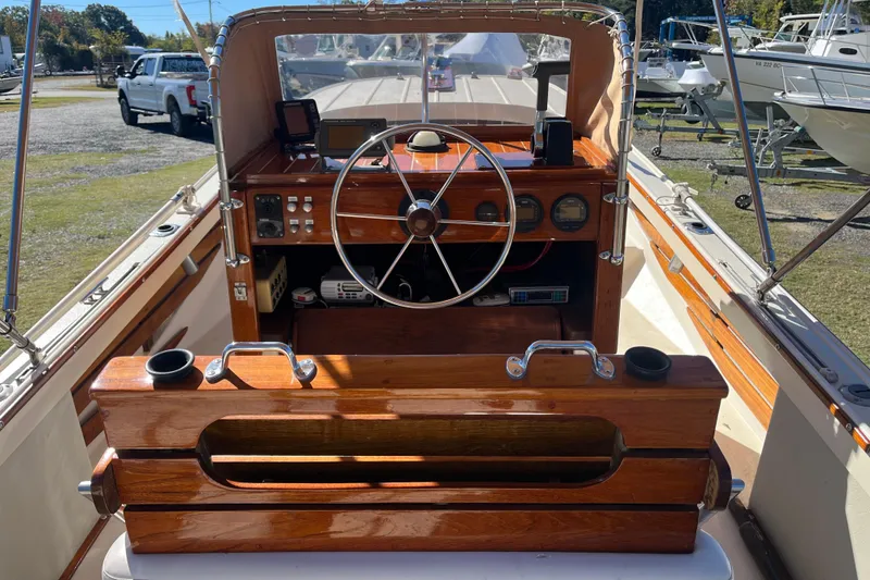 Slide: The Image of 1971 Boston Whaler 21 Outrage boat interior with wooden dashboard and steering wheel. - 1