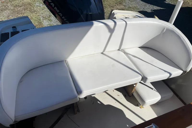 Slide: The Image of White seating on a 1971 Boston Whaler 21 Outrage boat, with Yamaha engine visible. - 10