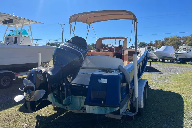 Slide: The Image of 1971 Boston Whaler 21 Outrage boat with outboard motor on a trailer. - 14