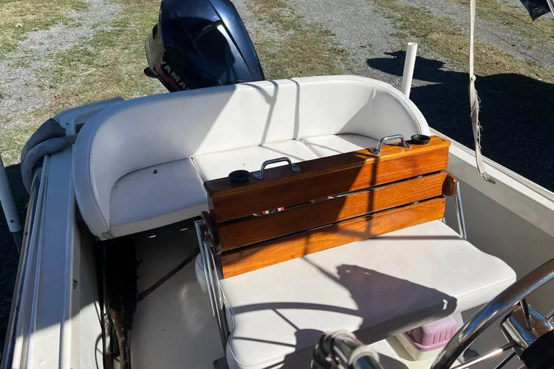 Slide: The Image of 1971 Boston Whaler 21 Outrage boat interior with wooden seat and Yamaha outboard motor. - 3