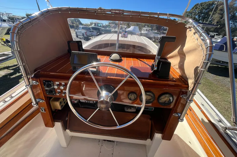 Slide: The Image of 1971 Boston Whaler 21 Outrage boat dashboard with steering wheel and navigation equipment. - 8