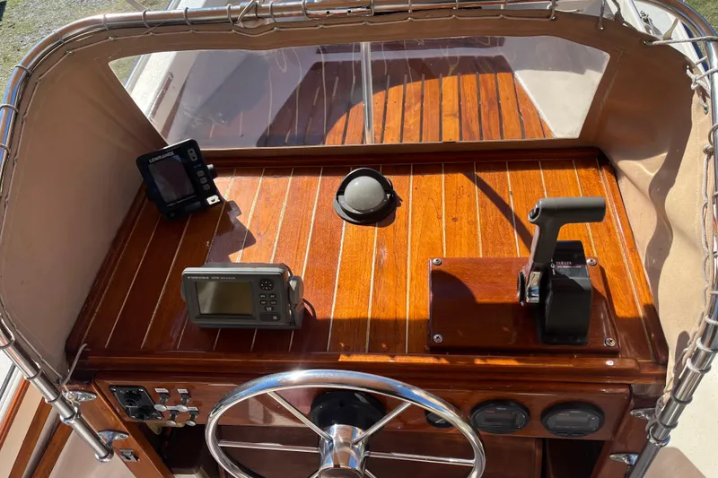 Slide: The Image of 1971 Boston Whaler 21 Outrage dashboard with wooden finish and navigation equipment. - 9