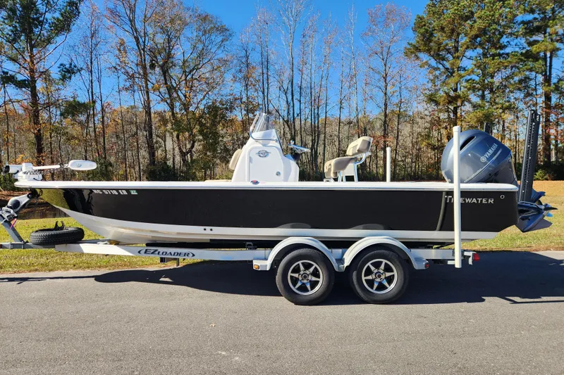 The Image of 2021 Tidewater 2110 Bay Max boat on trailer, parked on a road with trees in background. - 0