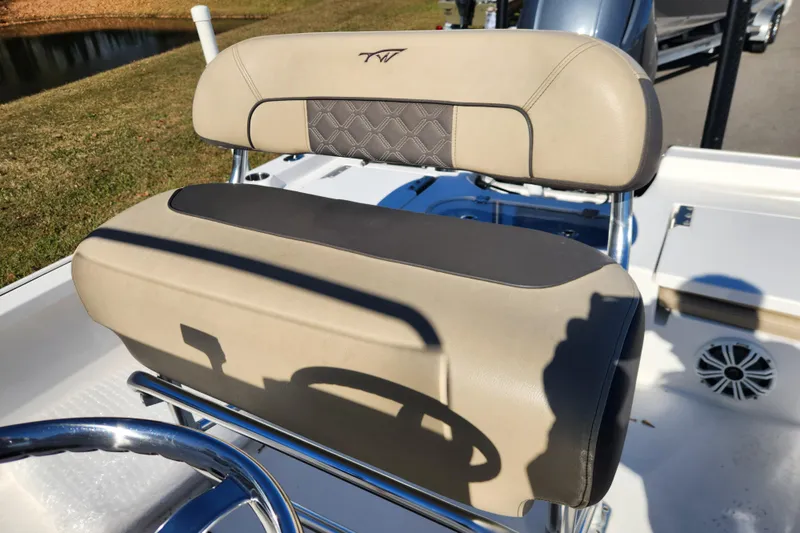 Slide: The Image of 2021 Tidewater 2110 Bay Max boat seat with beige upholstery and steering wheel. - 11