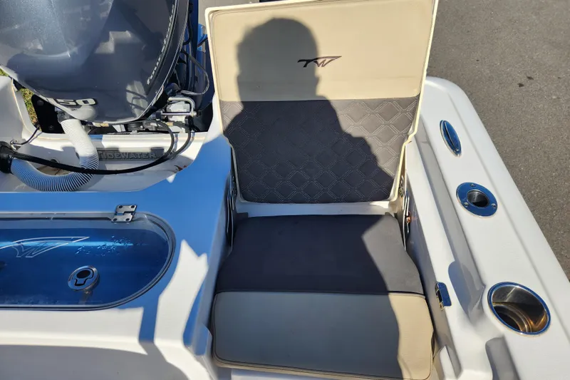 Slide: The Image of 2021 Tidewater 2110 Bay Max boat interior with seating and engine detail. - 15