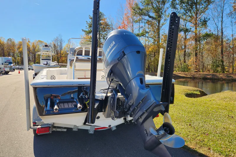 Slide: The Image of 2021 Tidewater 2110 Bay Max boat with Yamaha outboard motor, parked near a scenic pond. - 3