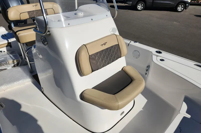 Slide: The Image of 2021 Tidewater 2110 Bay Max boat interior with beige seating and console. - 9