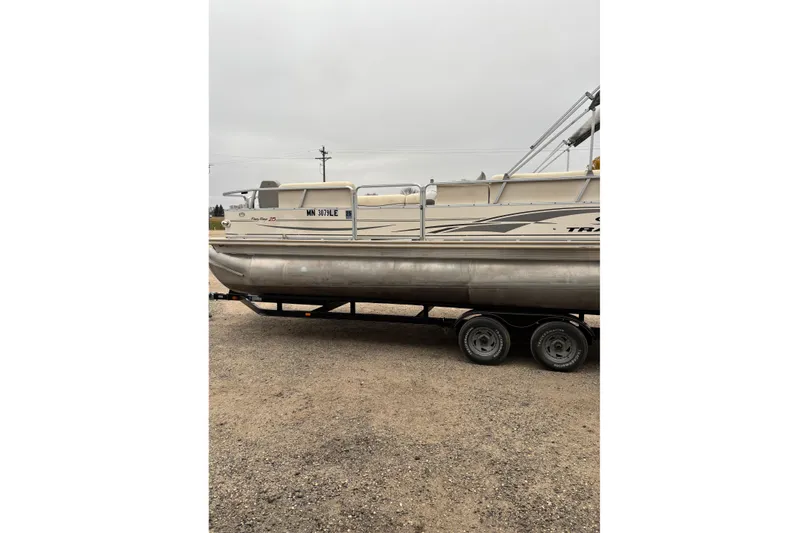 The Image of 2004 Sun Tracker Party Barge 25 I/O Regency Edition on trailer, side view. - 0