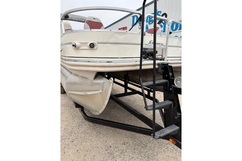 Slide: The Image of 2004 Sun Tracker Party Barge 25 I/O Regency Edition on trailer, side view. - 2