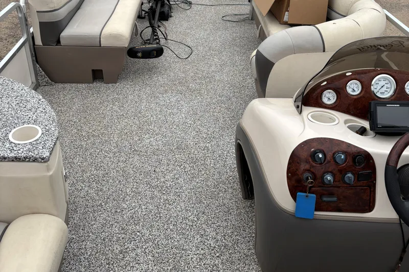 Slide: The Image of 2004 Sun Tracker Party Barge 25 I/O Regency Edition interior with seating and control panel. - 23