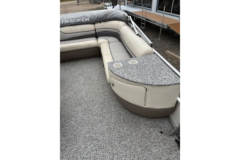 Slide: The Image of 2004 Sun Tracker Party Barge 25 I/O Regency Edition with cushioned seating and granite-style table. - 9