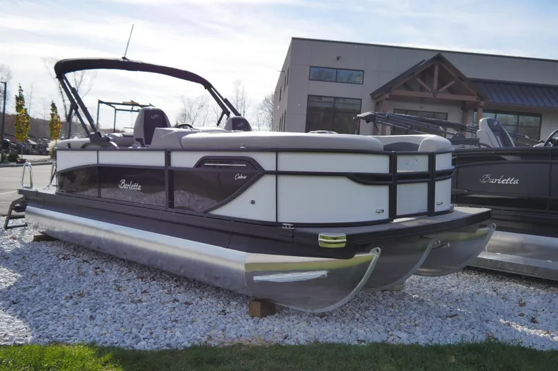The Image of 2026 Barletta Cabrio 22QC pontoon boat displayed outdoors on gravel. - 0