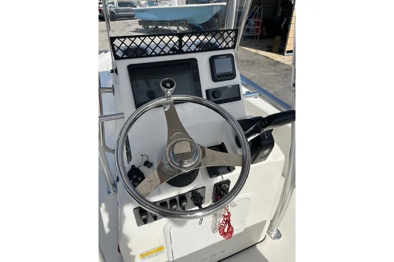 Slide: The Image of 2024 Palmetto 186 boat console with steering wheel and navigation controls. - 10