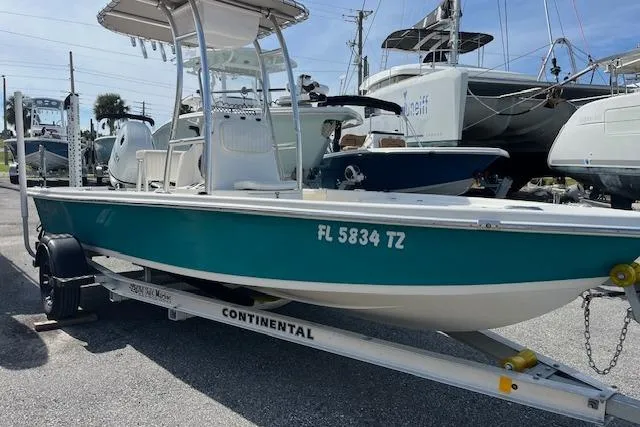 Slide: The Image of 2024 Palmetto 186 boat on trailer, teal hull, parked in marina. - 14