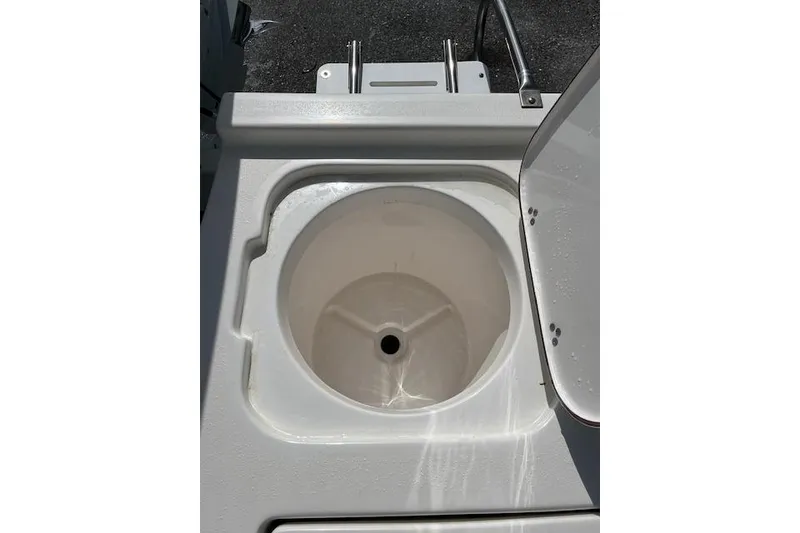 Slide: The Image of Open storage compartment on 2024 Palmetto 186 boat, featuring a circular basin design. - 2
