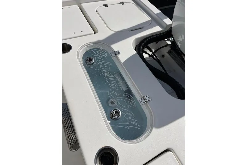 Slide: The Image of 2024 Palmetto 186 boat deck with storage compartments and logo detail. - 3