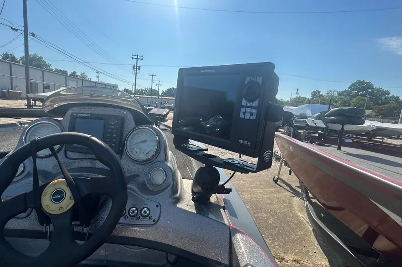 Slide: The Image of 2006 Nitro 482 DC boat dashboard with steering wheel and electronic display. - 13