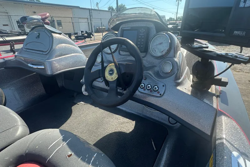 Slide: The Image of 2006 Nitro 482 DC boat dashboard with steering wheel and control panel. - 14