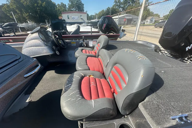 Slide: The Image of 2006 Nitro 482 DC boat interior with worn red and gray seats, steering console visible. - 7