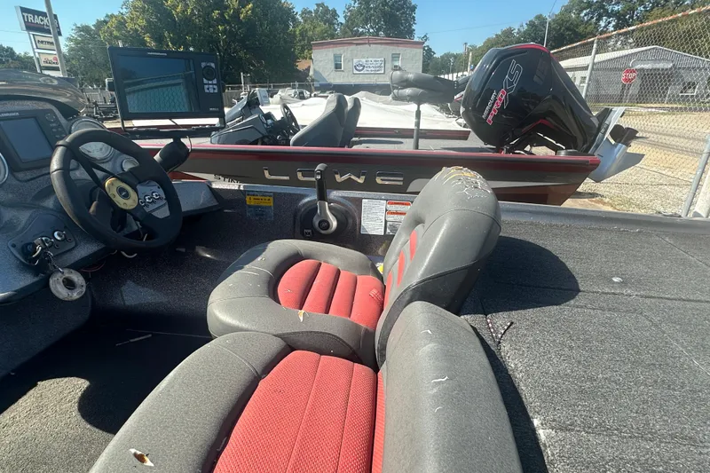 Slide: The Image of 2006 Nitro 482 DC boat interior with steering wheel and worn seats. - 8