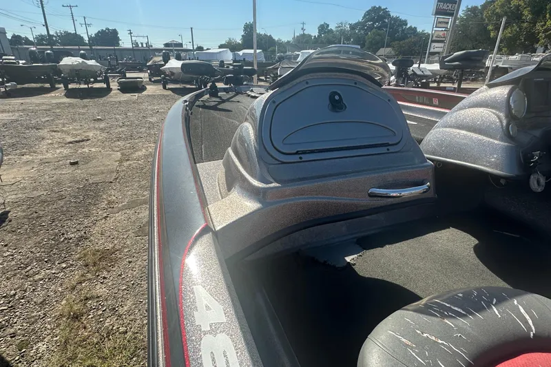 Slide: The Image of 2006 Nitro 482 DC boat interior with dashboard and seating, parked outdoors. - 9