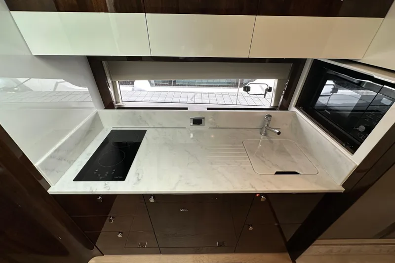 Slide: The Image of Modern kitchen in 2026 Fairline Targa 45 GT yacht with sleek countertops and appliances. - 16