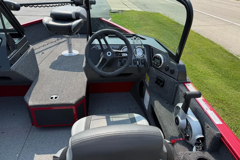 Slide: The Image of 2025 Lund 1675 Adventure Sport boat interior with steering wheel and controls. - 11