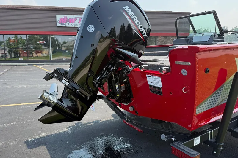 Slide: The Image of 2025 Lund 1675 Adventure Sport boat with Mercury outboard motor, parked outdoors. - 5