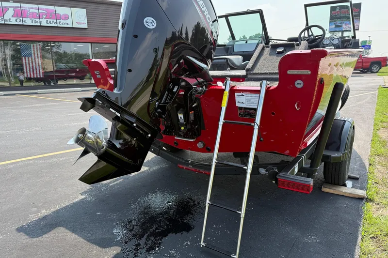 Slide: The Image of 2025 Lund 1675 Adventure Sport boat with outboard motor and ladder in parking lot. - 6