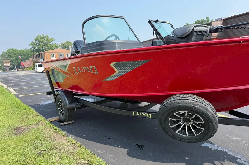Slide: The Image of 2025 Lund 1675 Adventure Sport boat in vibrant red on a trailer. - 7