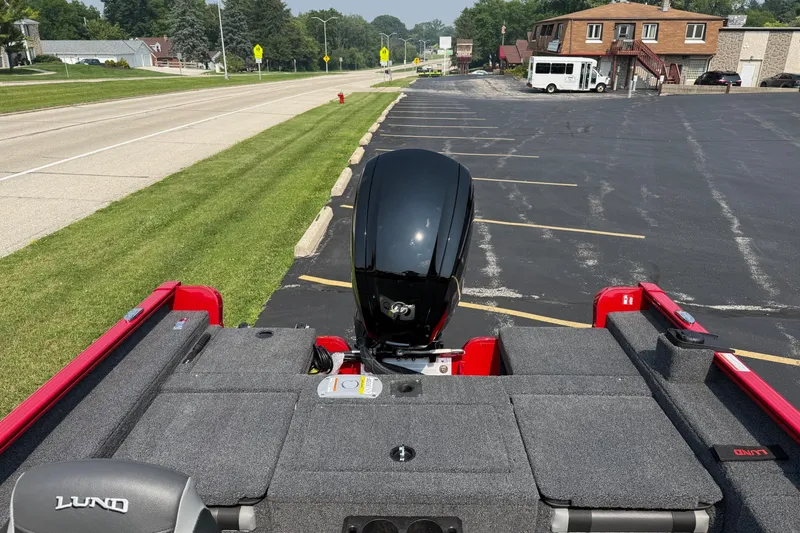 Slide: The Image of 2025 Lund 1675 Adventure Sport boat parked, showcasing rear motor and seating area. - 9