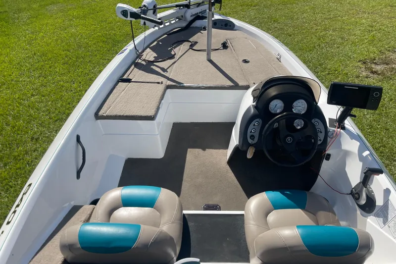 Slide: The Image of 2006 Nitro 640 LX boat interior with steering console and seating on grassy area. - 11