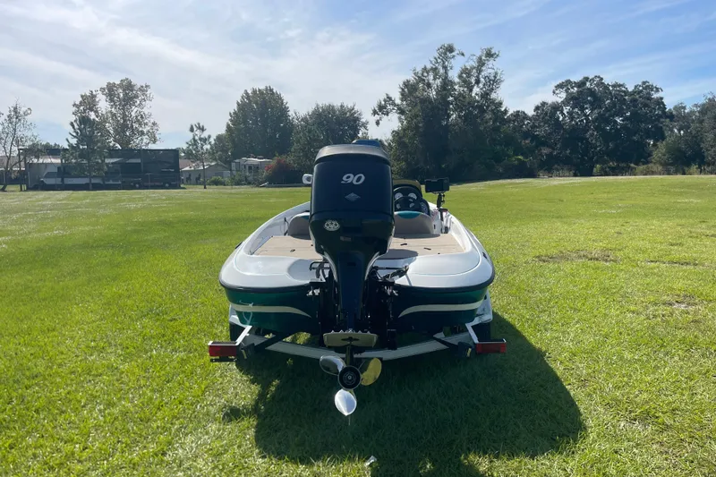 Slide: The Image of 2006 Nitro 640 LX boat on grassy field, rear view with outboard motor. - 3